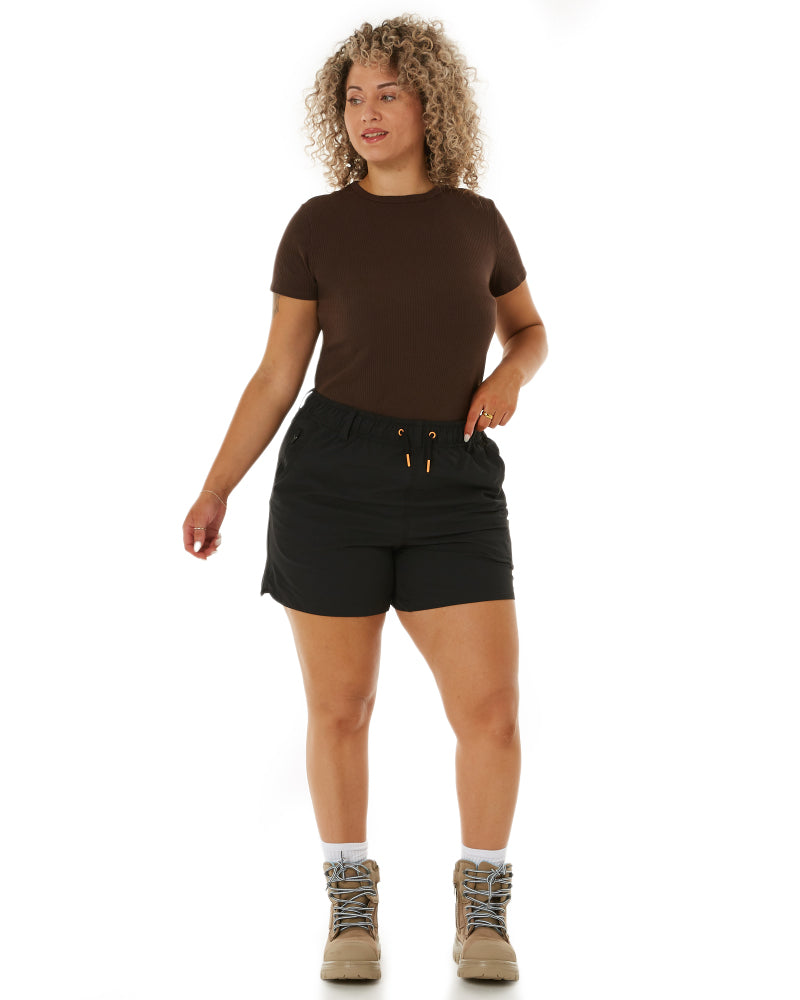 Model showcasing Zadie Workwear's 'The Workz' pants in black, highlighting the high-waisted design and functional pockets.