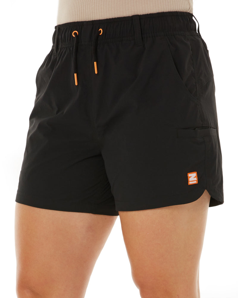 Woman wearing Zadie Workwear's high-waisted navy 'Workz Pant' designed for comfort and durability.