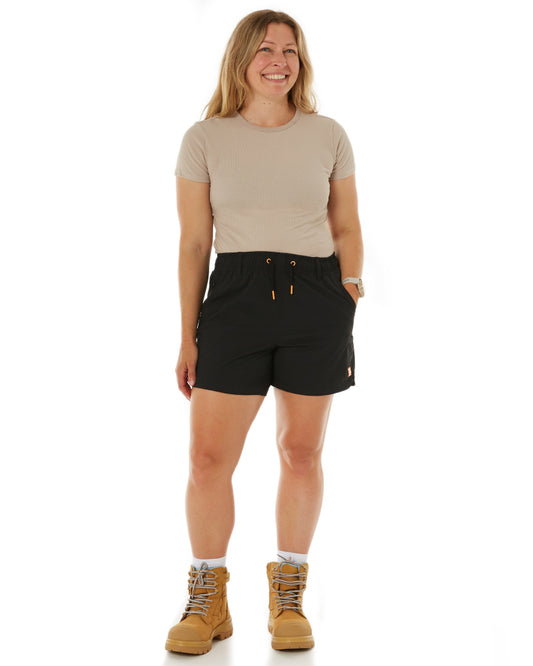 Model wearing Zadie Workwear's 'The Middy' shorts in black, designed for breathability and comfort during hot days.