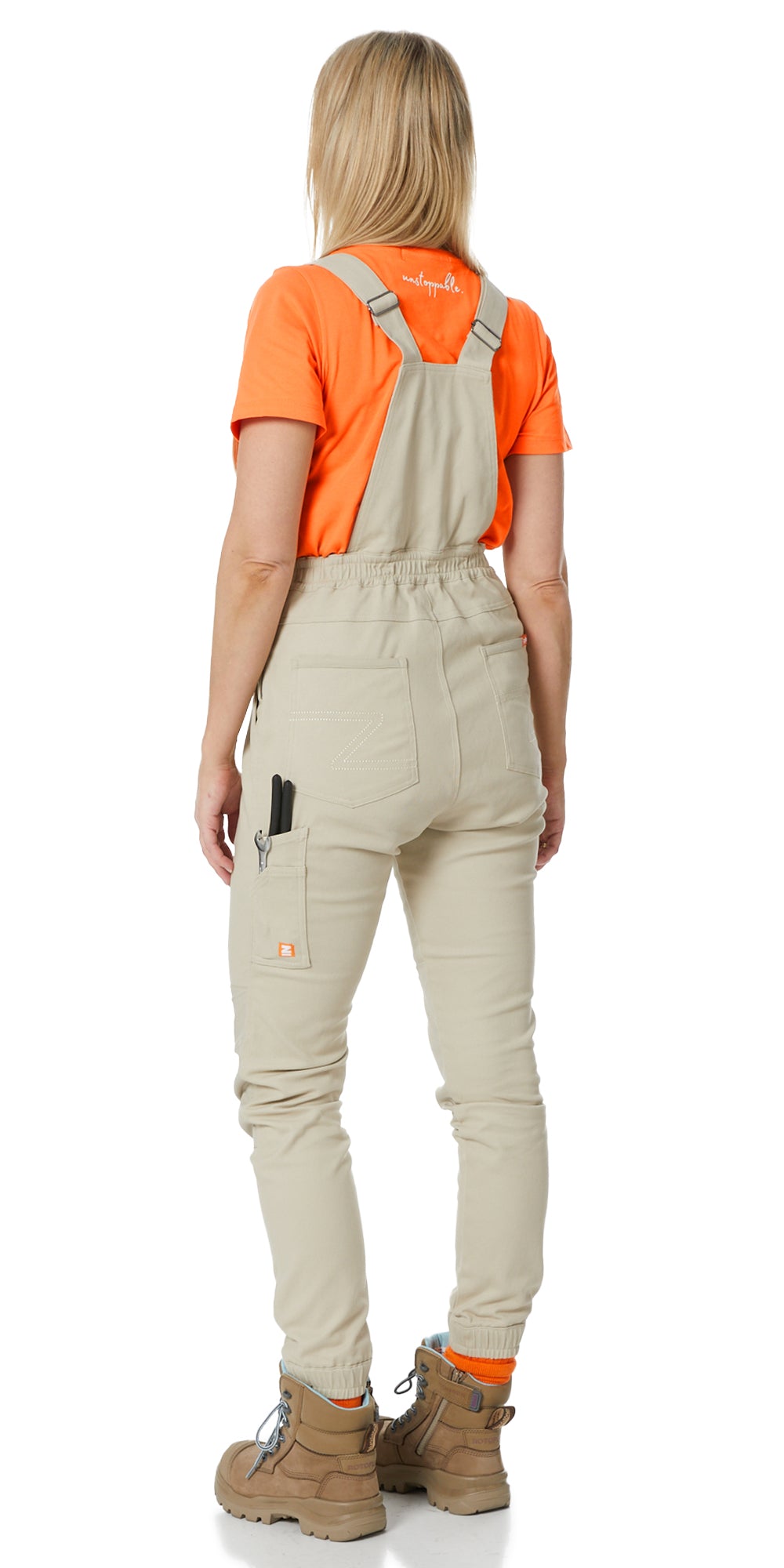 A woman showcasing flexible and durable workwear in action.