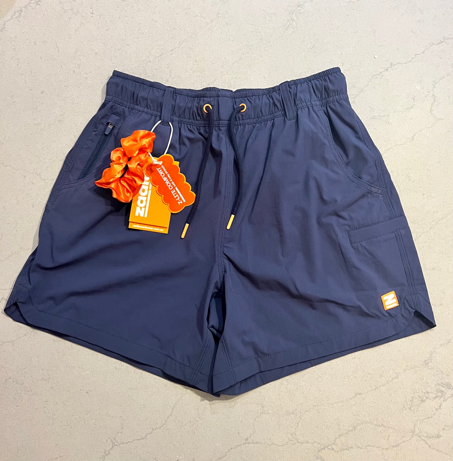 Close-up of Zadie Workwear's 'The Middy' shorts in navy, showcasing the mid-rise fit and durable fabric.