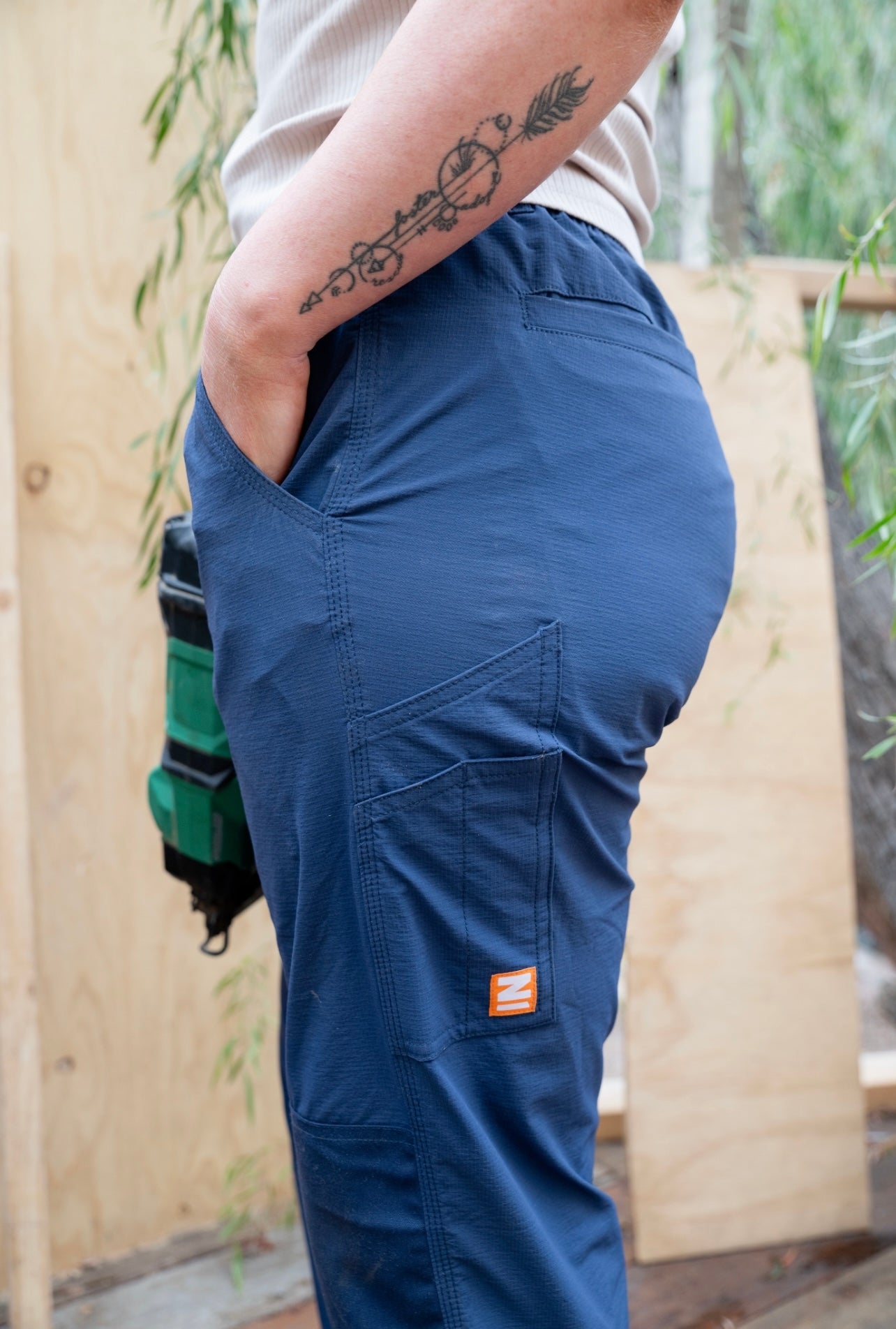 Woman wearing Zadie Workwear's high-waisted 'Workz' pants in navy, designed for comfort and durability.