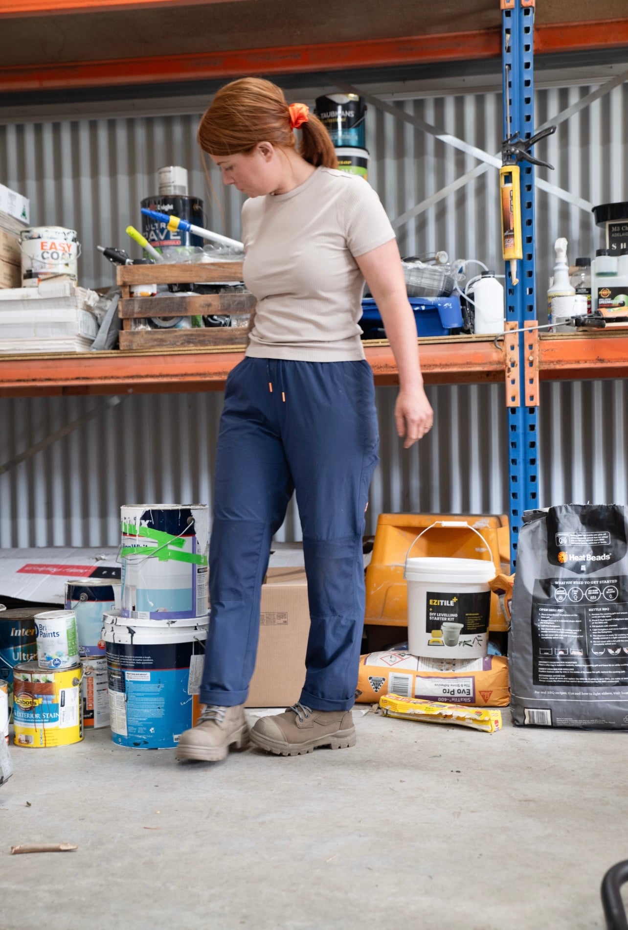 Woman wearing Zadie Workwear's high-waisted black work pants, showcasing a contoured fit.