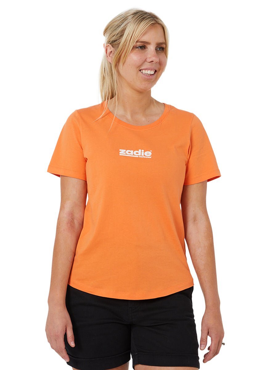 Unstoppable Tee in orange, featuring a vibrant and practical design for work environments.